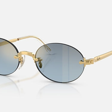 Ray-Ban RB3929 by A$AP Rocky 001/S2 arista goud, glazen in blauw met kleurverloop naar donkergrijs – schuin vooraanzicht